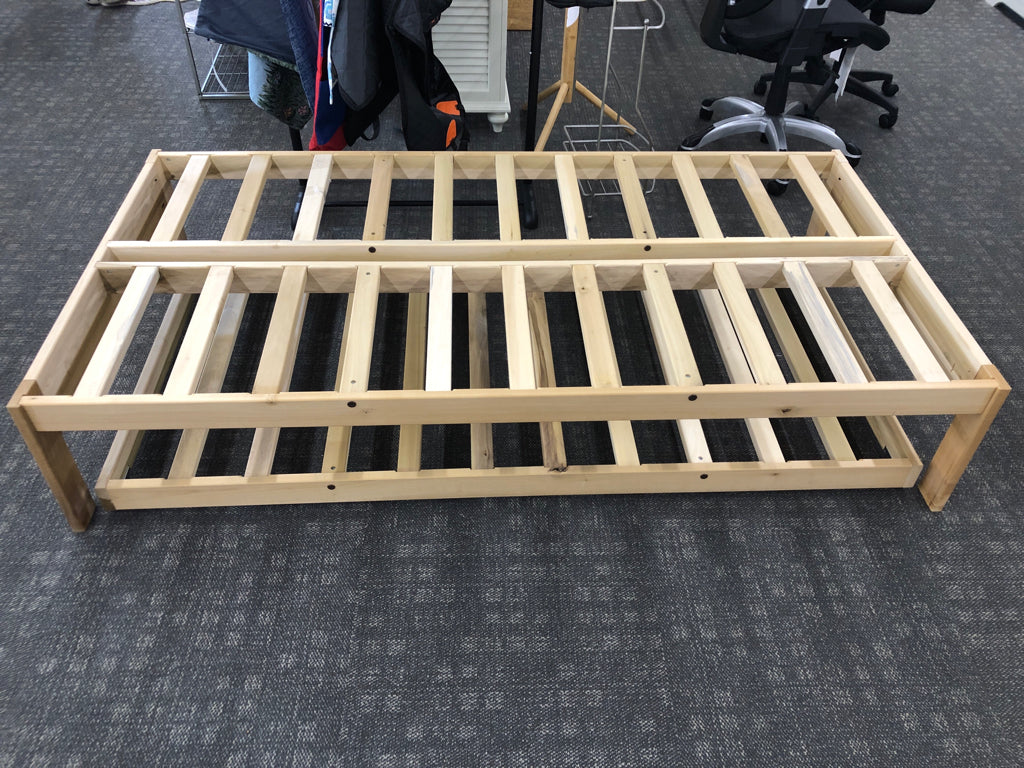 LIGHT WOOD TWIN PLATFORM WITH TRUNDLE BED.