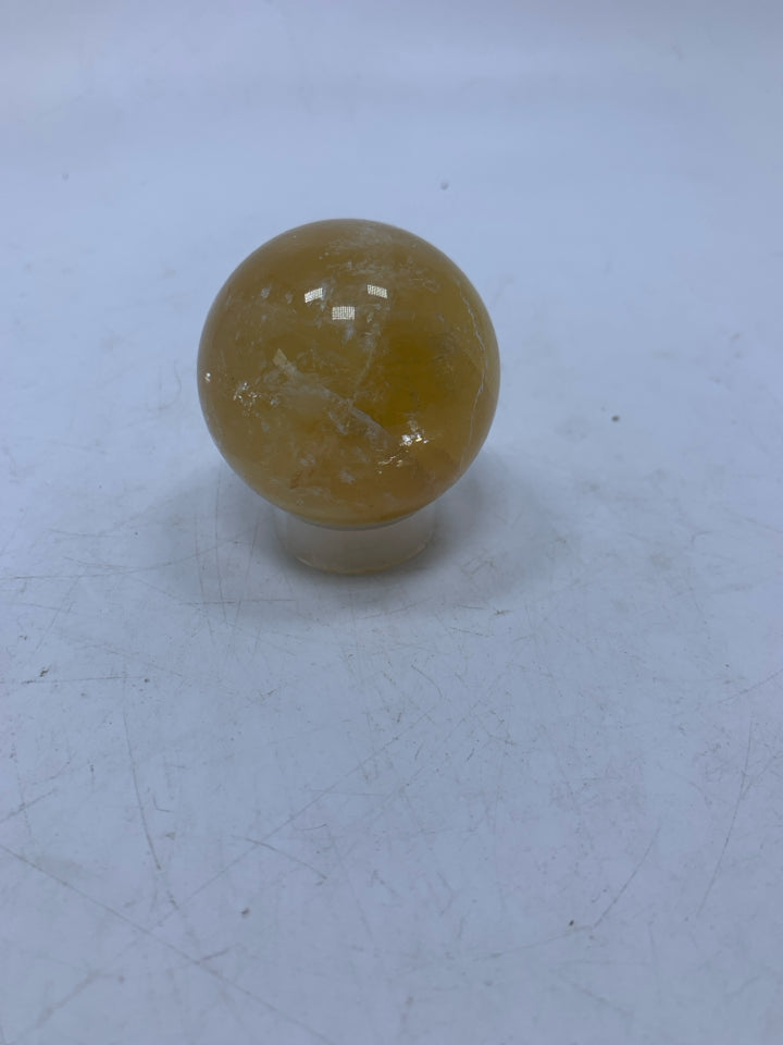 YELLOW STONE SPHERE W/ STAND IN BAG.