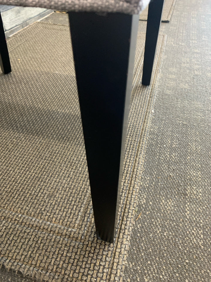 DARK GREY ACCENT CHAIR W/ BLACK LEGS STUDDED EDGE.