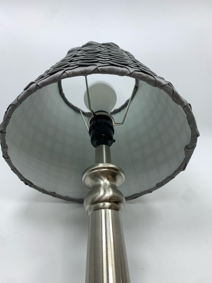 SILVER METAL BASE LAMP W/GREY PLEATED SHADE.