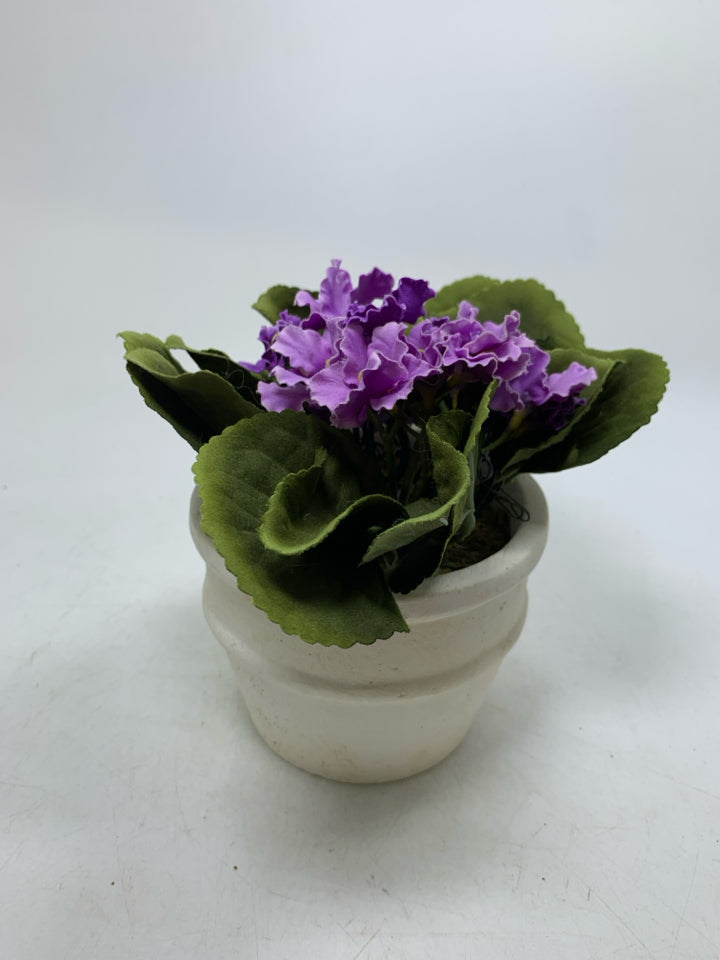 CREAM PLANTER W/ FAUX PURPLE FLOWERS AND LIGHTS.