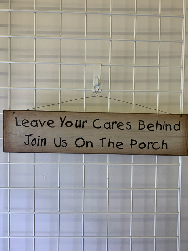 "LEAVE YOUR CARES BEHIND" WOOD WALL HANGING.