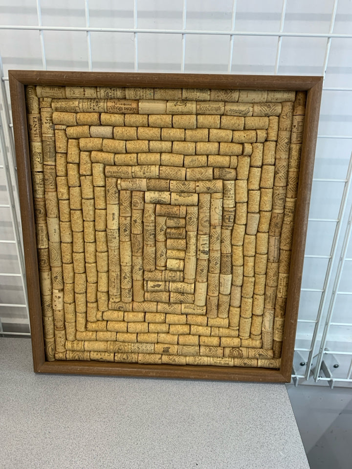 CORKS IN A BROWN FRAME.