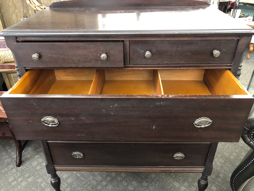 VTG DARK WOOD DRESSER W/5 DRAWERS & ORNATE METAL PULLS ON WHEELS.