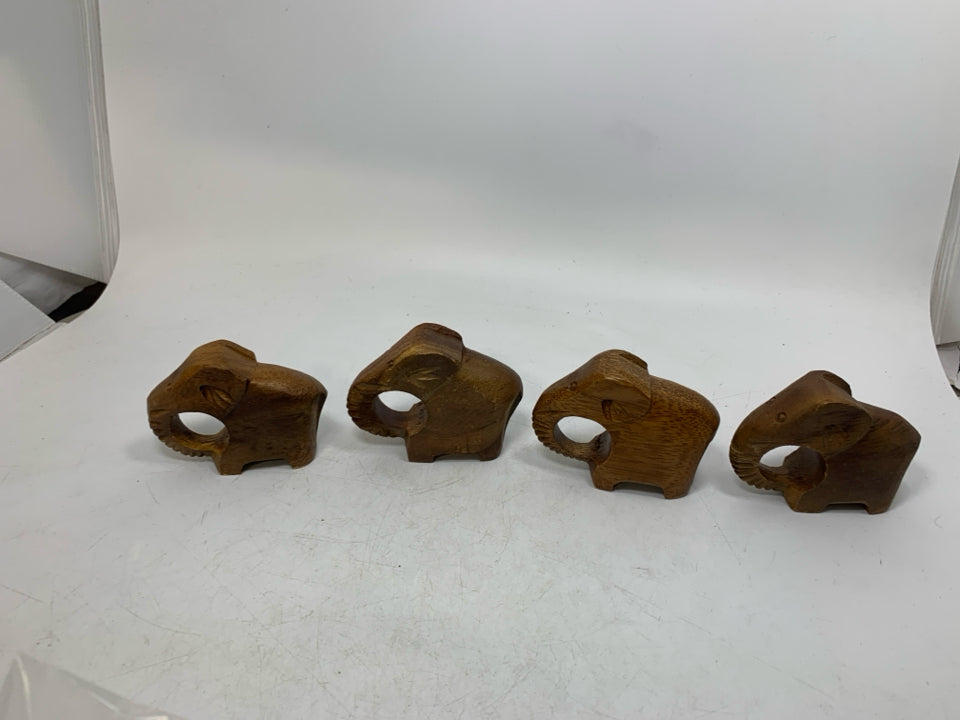 4 WOOD CARVED ELEPHANT NAPKIN RINGS IN BAG.