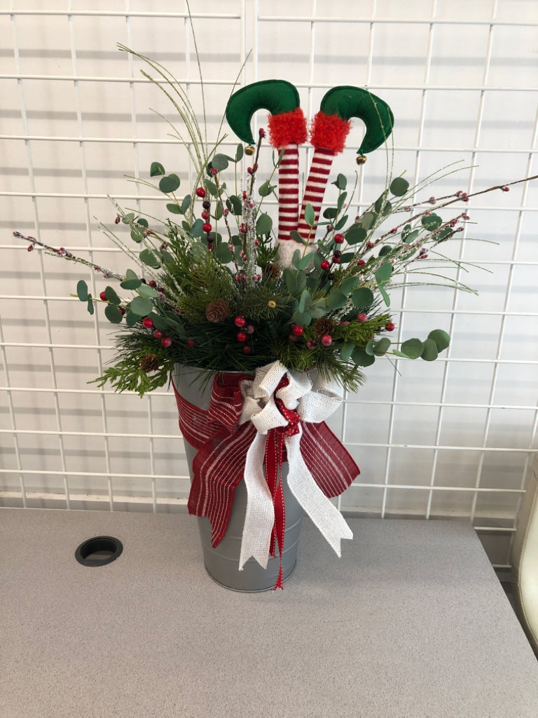 FAUX GREEN AND BERRIES ELF LEGS IN TIN W/RED RIBBON.