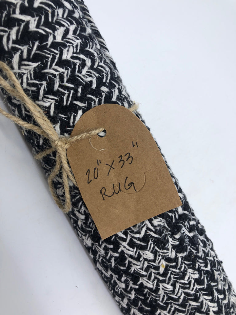 BLACK AND WHITE JELLY ROLL RUG.