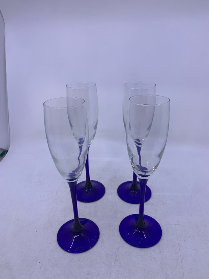 4 CLEAR GLASS CHAMPAGNE FLUTES W/ COBALT BLUE STEMS.