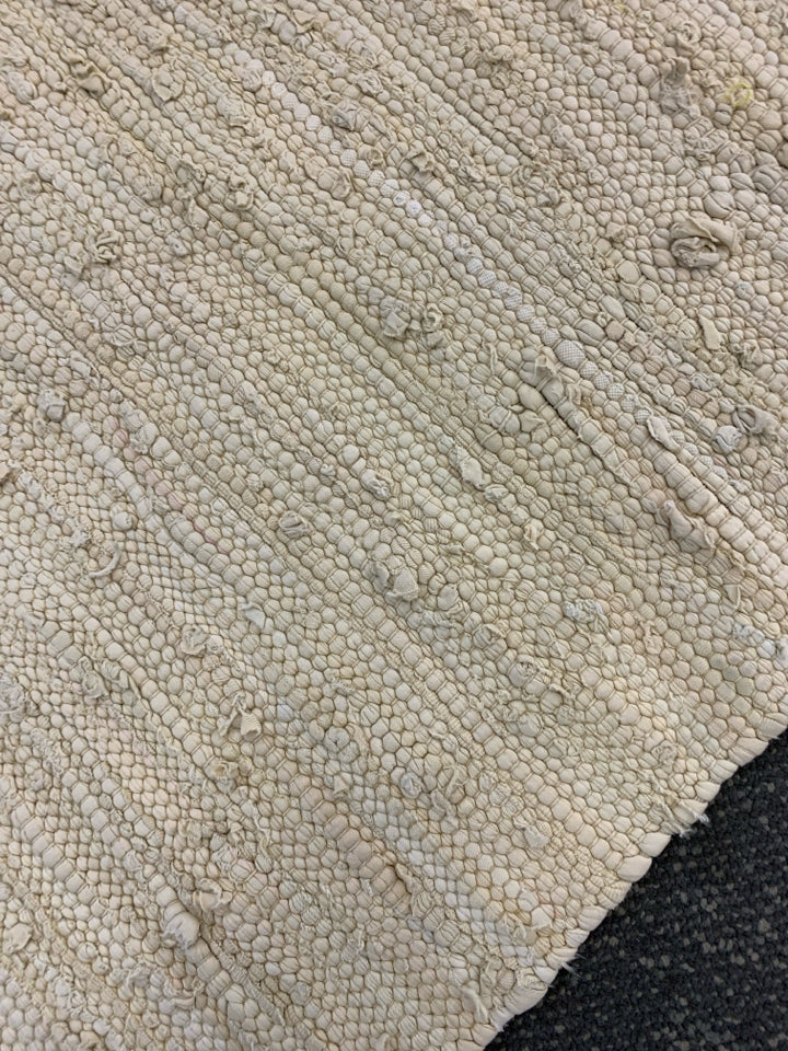 WOVEN FABRIC BEIGE RUG.