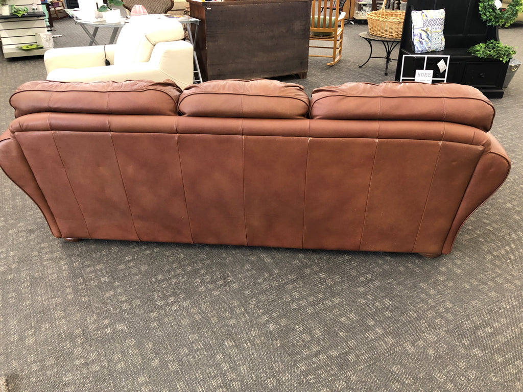 BROWN FAUX LEATHER COUCH.