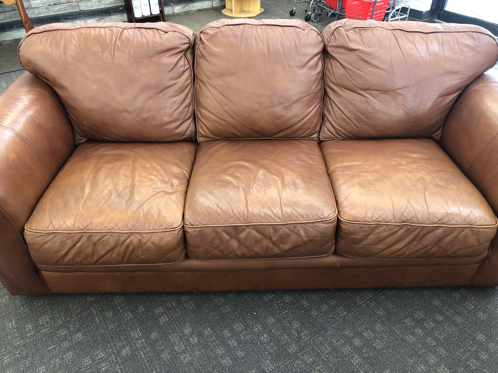 BROWN FAUX LEATHER COUCH.