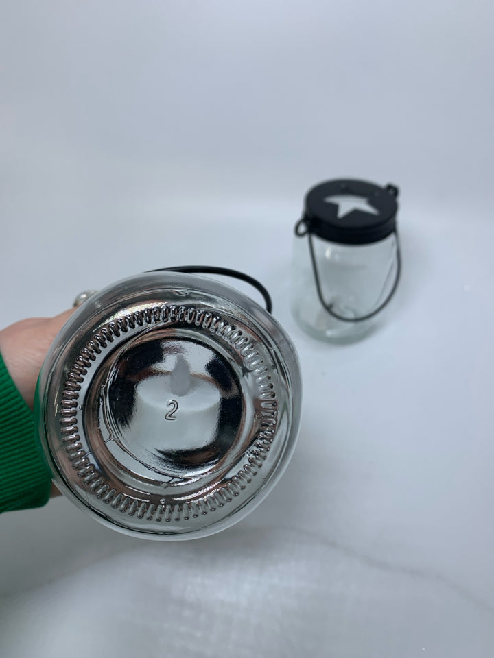 2 GLASS MASON JAYS W/ STAR CUT OUT CAP LANTERN.