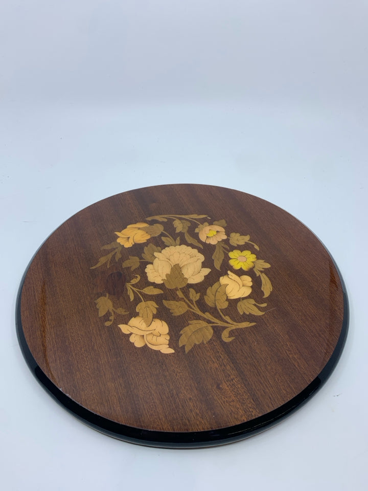 INLAID FACTORY WOOD TRIVET W/ FLORAL DESIGN IN CENTER.