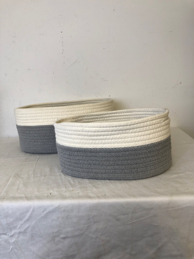 2 GREY AND WHITE OVAL NESTING BASKETS.