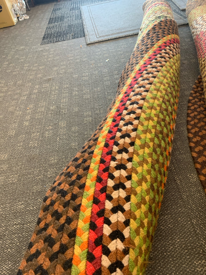 BROWN, RED, GREEN OVAL BRAIDED RUG.