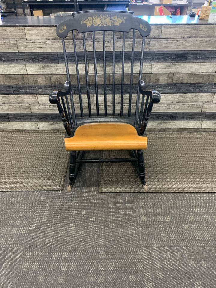 BLACK WOOD ROCKING CHAIR W FRUIT DETAILING.