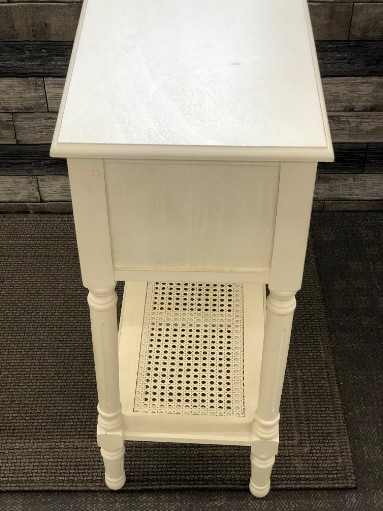 WHITE WOOD SIDE TABLE W/3 DRAWERS AND CANE BOTTOM SHELF.