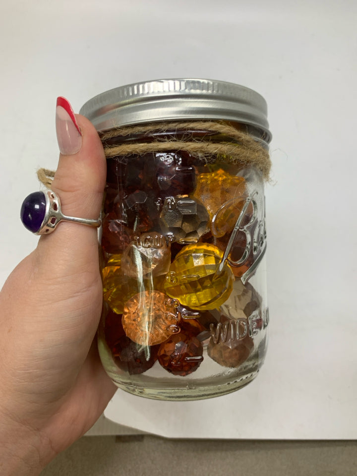 JAR OF PUMPKIN BEADS.