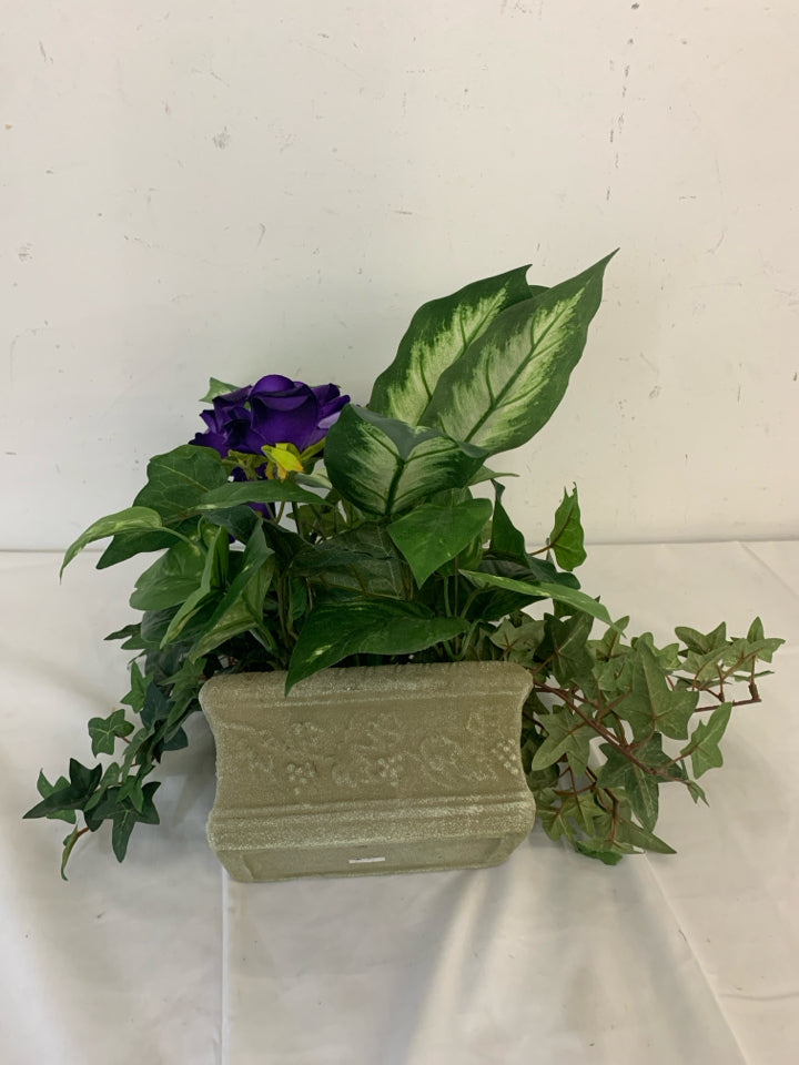 FAUX PURPLE FLOWERS IN GREEN PLANTER.