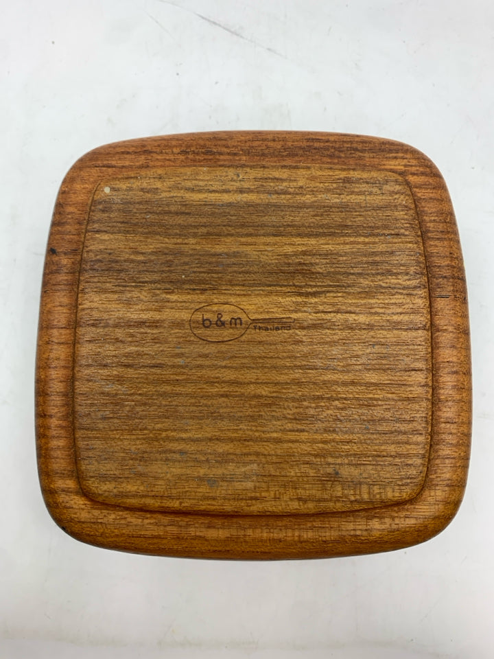 6 CARVED WOODEN COASTERS IN HOLDER.