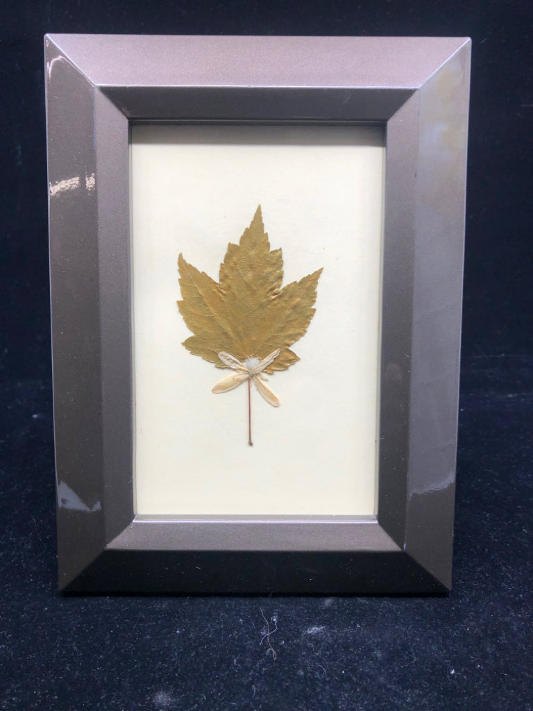 GOLD LEAF IN BRONZE COLORED FRAME.