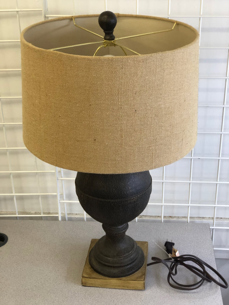 DARK BROWN TEXTURED BASE ON WOOD SLAB W/ BURLAP SHADE.