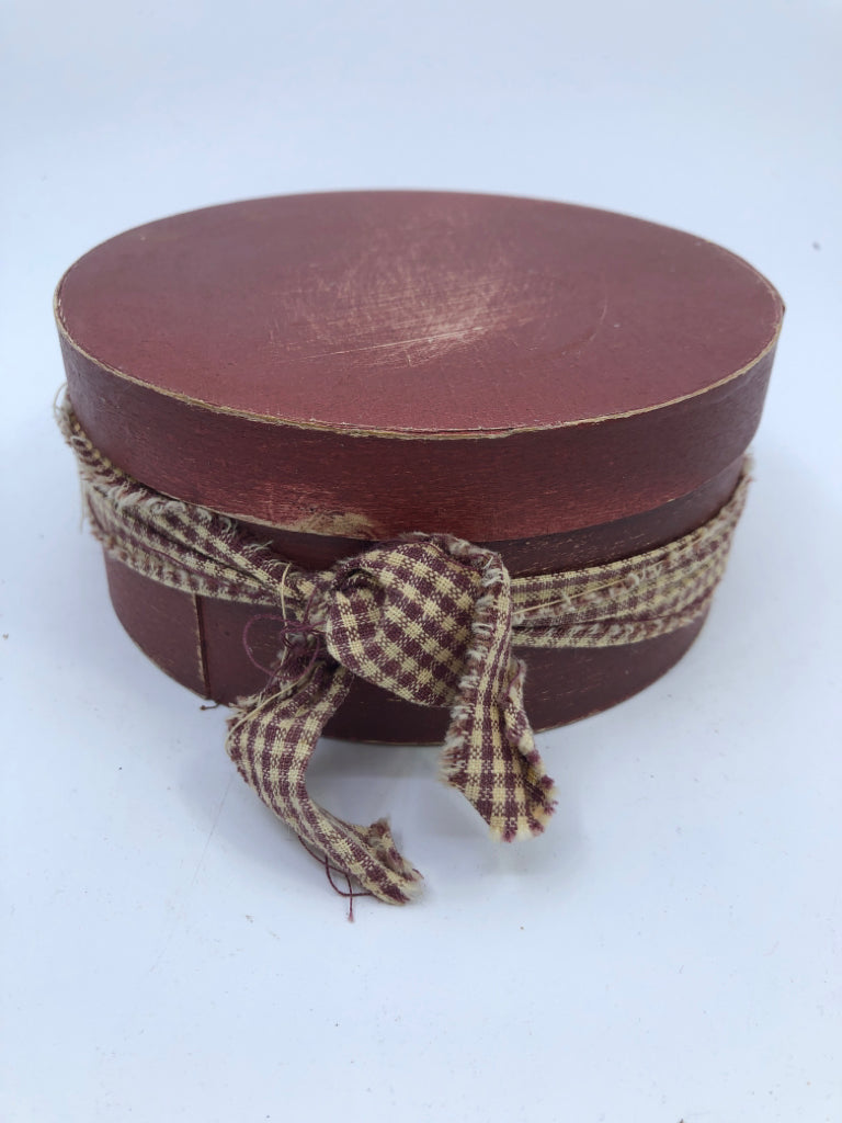 ROUND RED BOX W PLAID RIBBON.