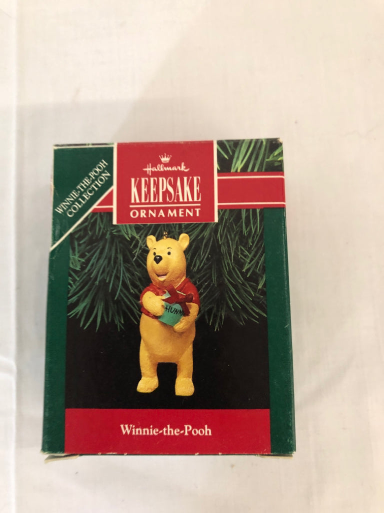 WINNIE THE POOH HOLDING HONEY ORNAMENT.