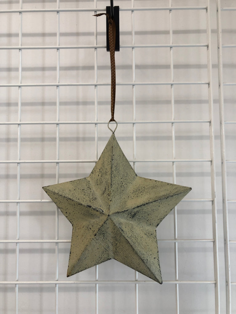 TAN WASHED METAL STAR HANGING.