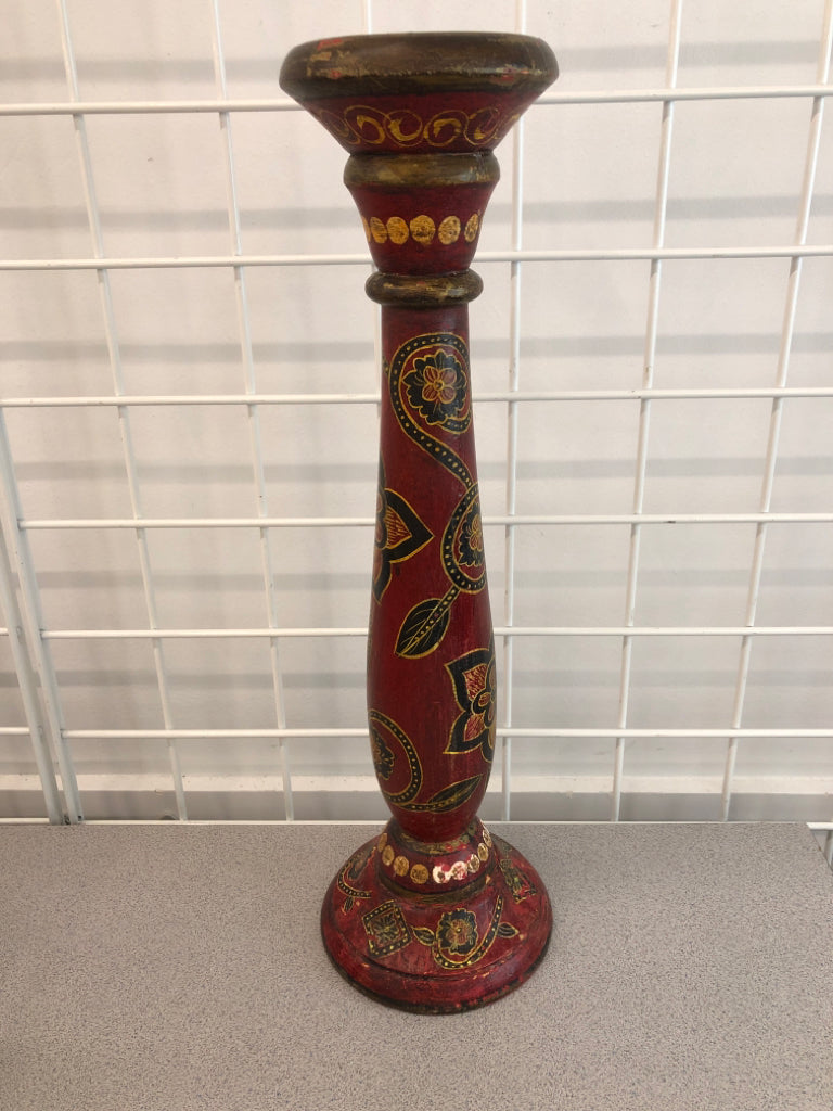 RED WOOD PILLAR CANDLE HOLDER W/BLACK FLOWERS.