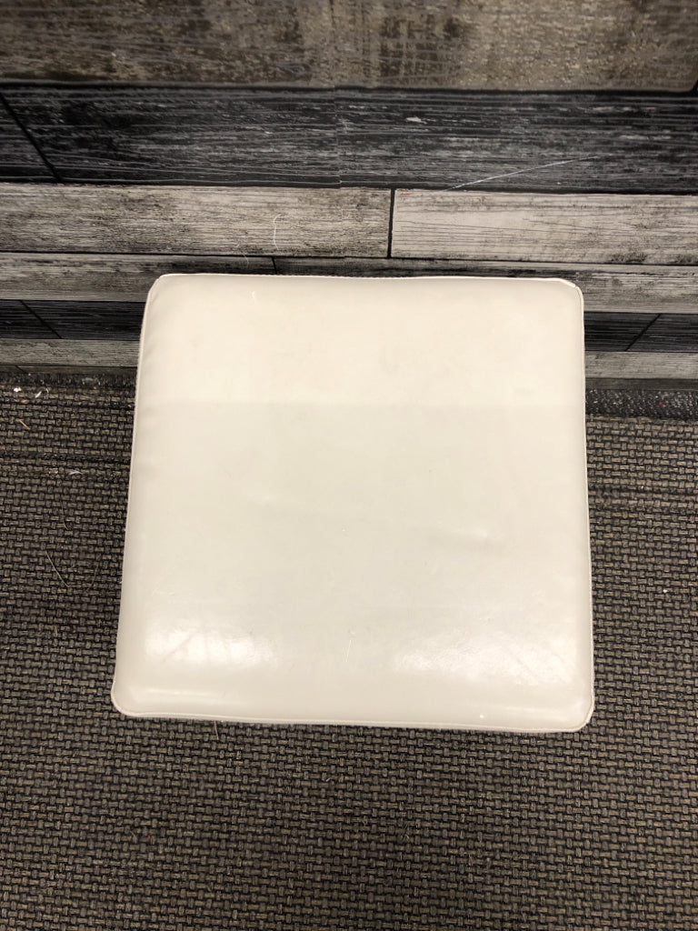 WHITE FAUX LEATHER OTTOMAN.