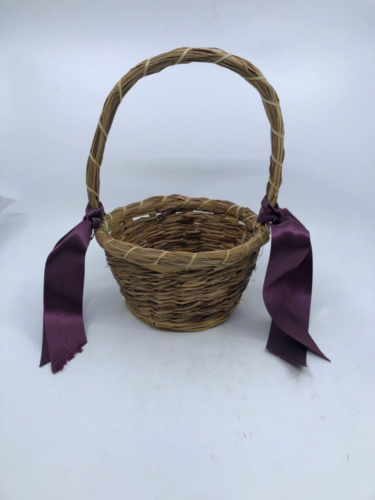 WICKER BASKET W/HANDLE AND PURPLE RIBBONS.