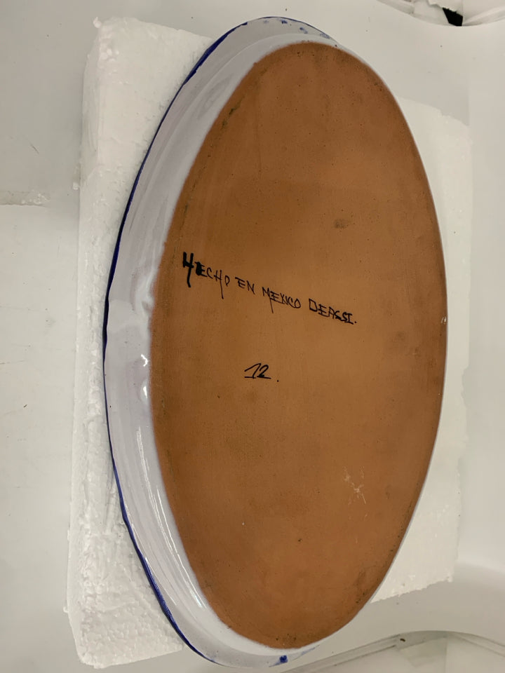 LARGE OVAL TERRA COTTA PLATTER W/ WHITE FLOWERS DARL BLUE BACKGROUND.