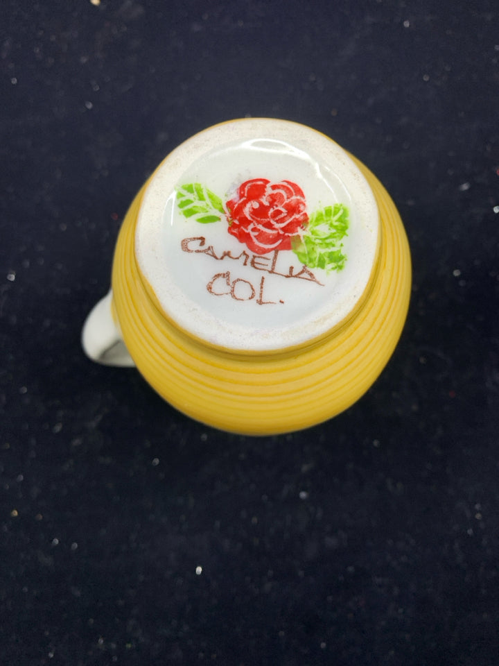 YELLOW AND BLUE FLORAL CREAMER.