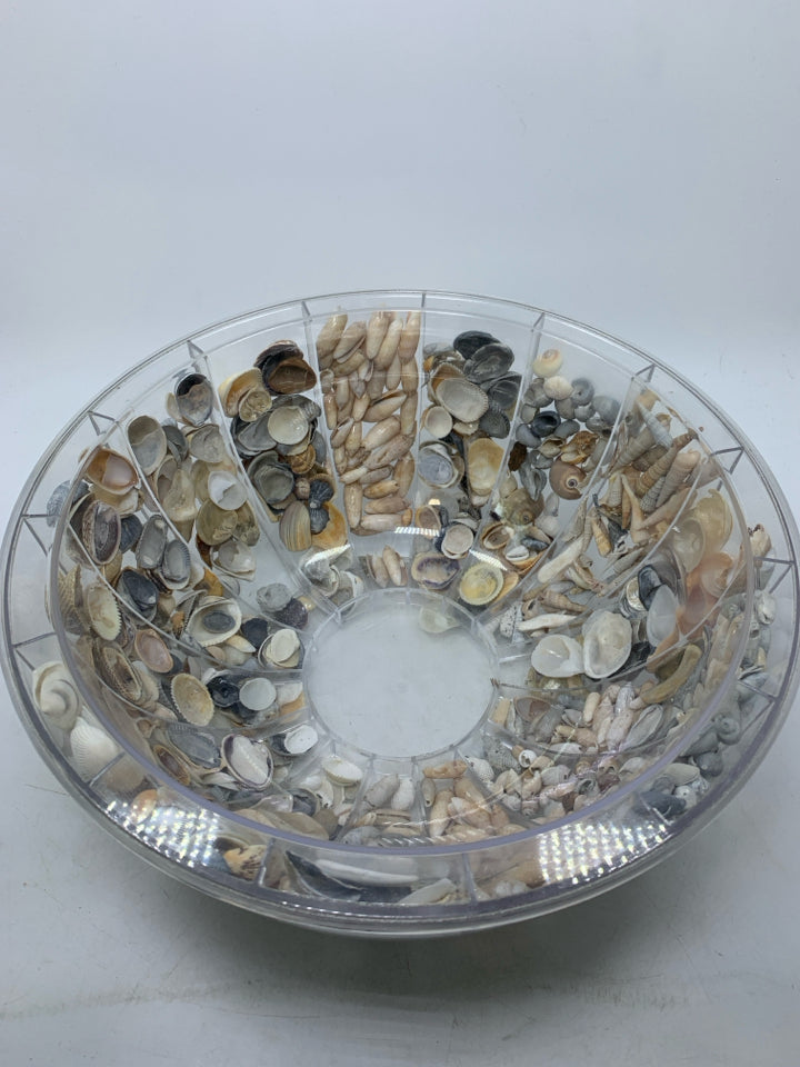 CLEAR PLASTIC BOWL FILLED W/ SHELLS INSIDE.