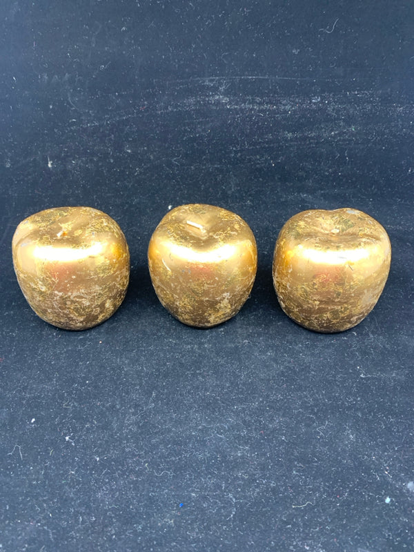 3 GOLD APPLE SHAPED CANDLES.