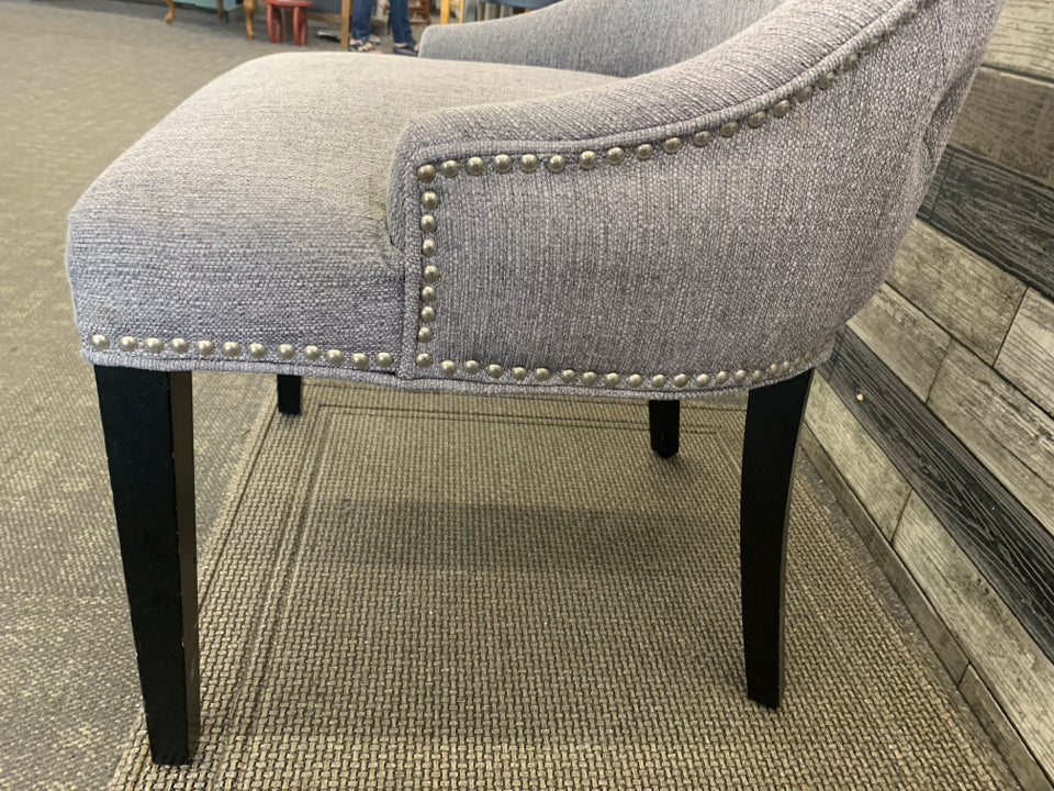 DARK GREY ACCENT CHAIR W/ BLACK LEGS STUDDED EDGE.