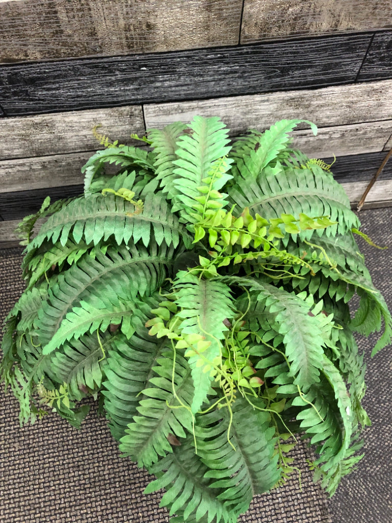 FAUX FERN IN BROWN CERAMIC PLANTER.