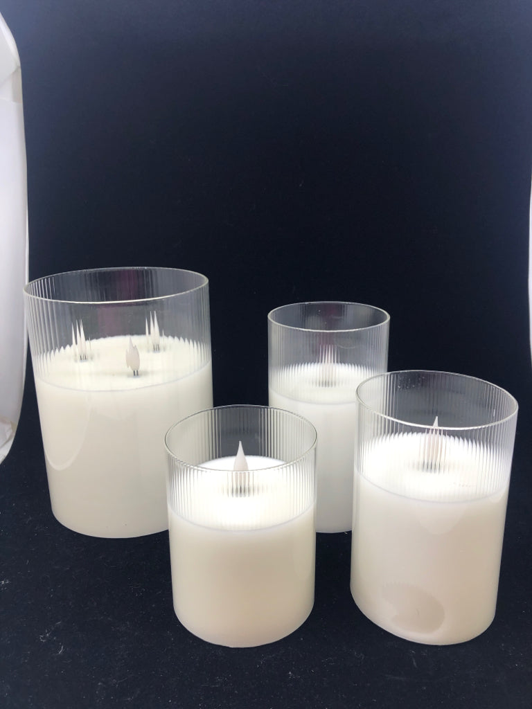 4 LIGHT UP PILLAR GLASS CANDLES.
