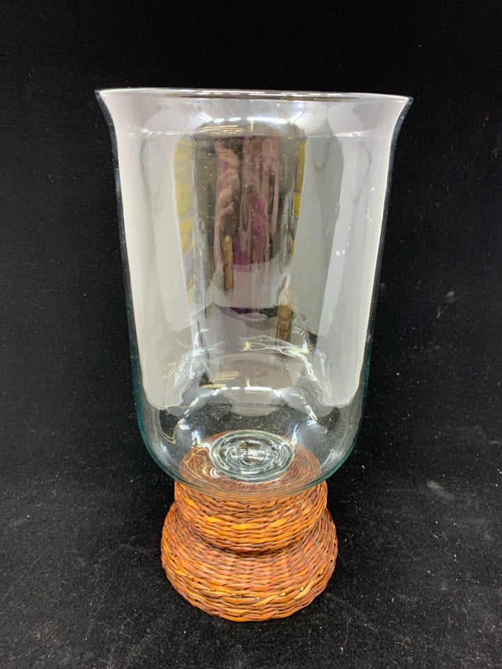 LARGE GLASS CENTERPIECE W/BROWN WICKER BASE.