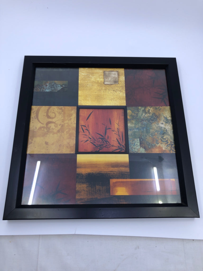 RED SQUARE PATTERN W BLACK LEAVES WALL ART IN BLACK FRAME.