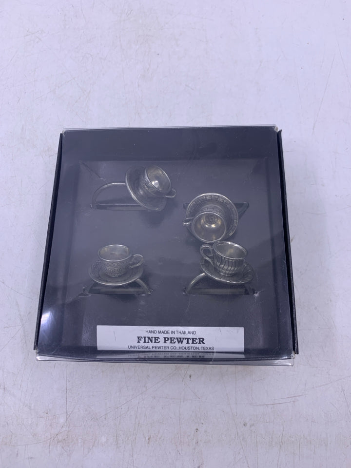 IN BOX 4 PEWTER TEACUP NAPKIN RINGS.