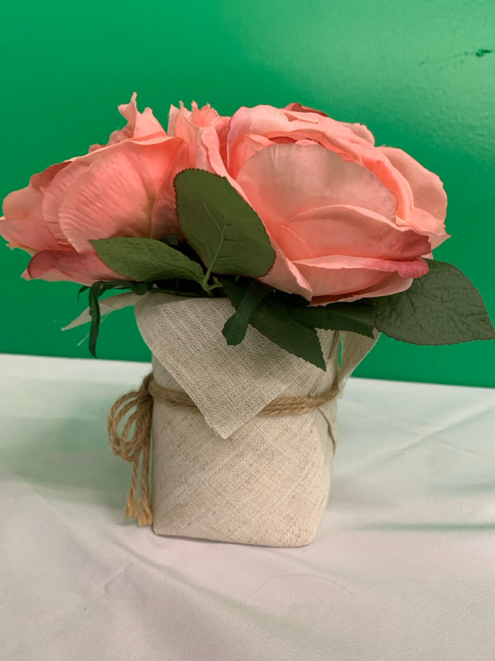 FAUX PINK FLORAL IN BURLAP PLANTER.
