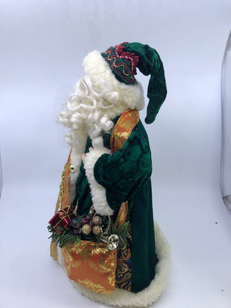 STANDING HOLLOW SANTA W/ DARK GREEN JACKET HOLDING STAKE.