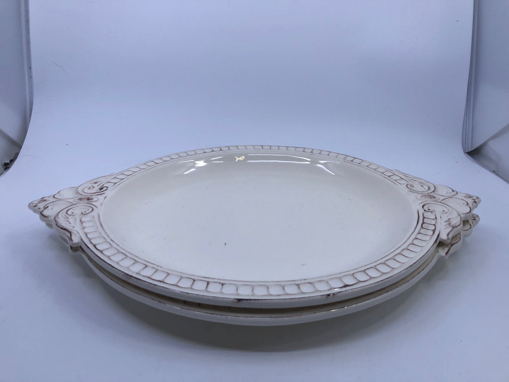 2 OVAL CREAM SCROLL DESIGN PLATTERS.