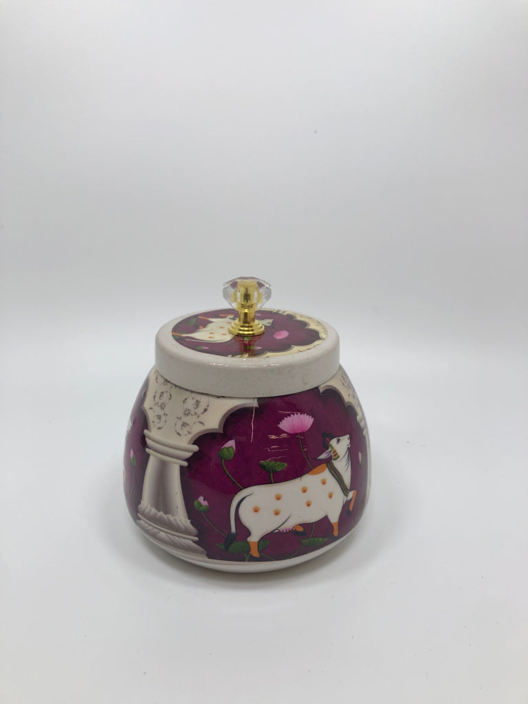 WHITE METAL JAR W/COW PRINT AND LID.