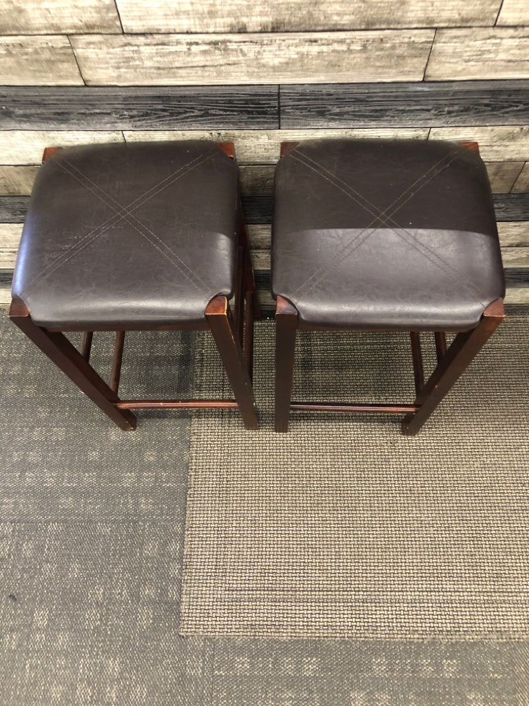 2 FAUX LEATHER UPHOLSTERED WOOD STOOLS.
