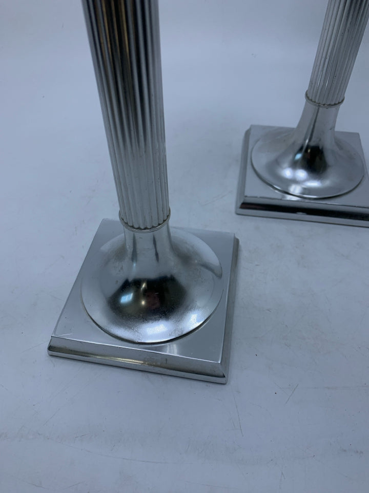 2 TALL SILVER METAL PILLAR CANDLE HOLDERS.