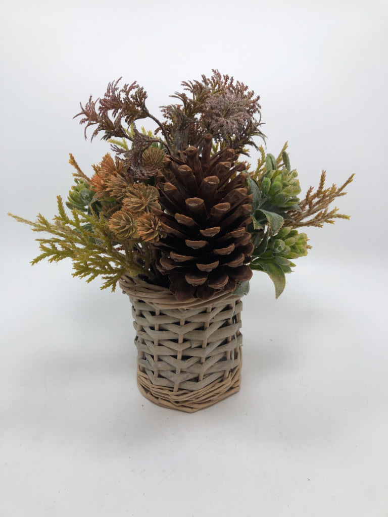 SM FAUX GREENERY ARRANGEMENT W/PINECONES IN WICKER VASE.