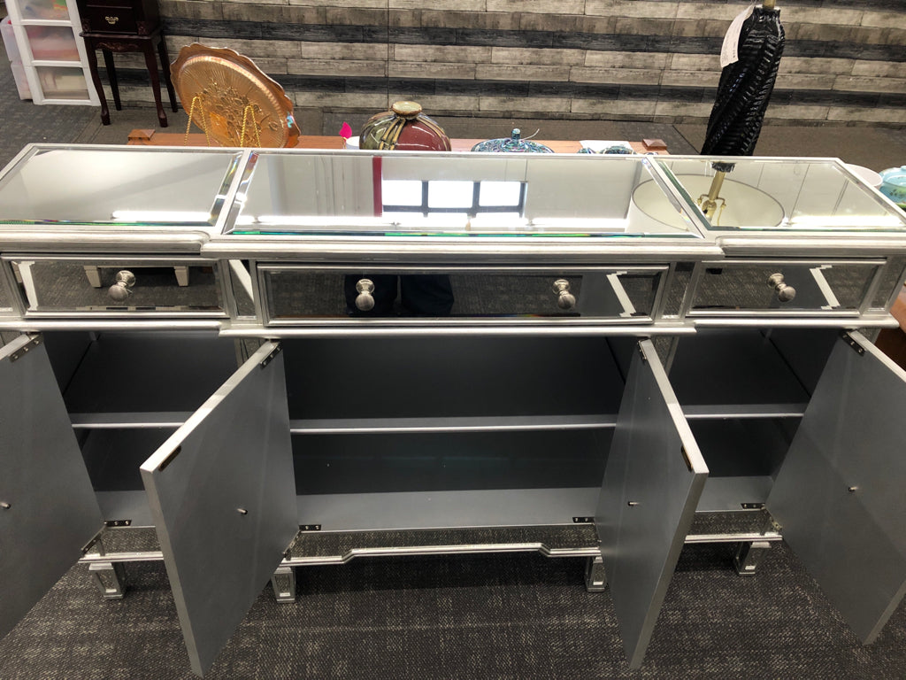 MIRRORED CONSOLE TABLE W/3 DRAWERS & 4 DOORS.